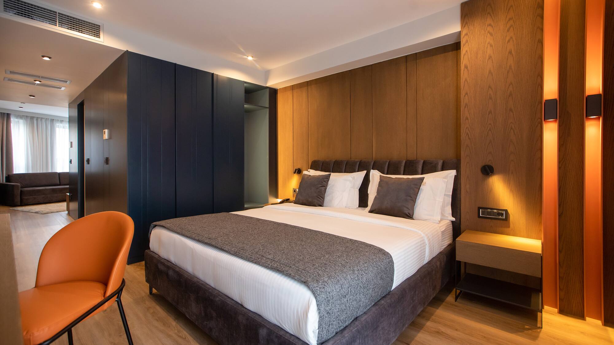 a bed with a chair and a desk in a room