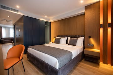 a bed with a chair and a desk in a room