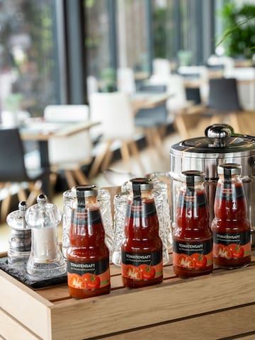 a group of bottles of sauce on a wooden table