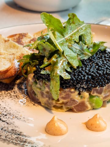 a plate of food with a glass of wine