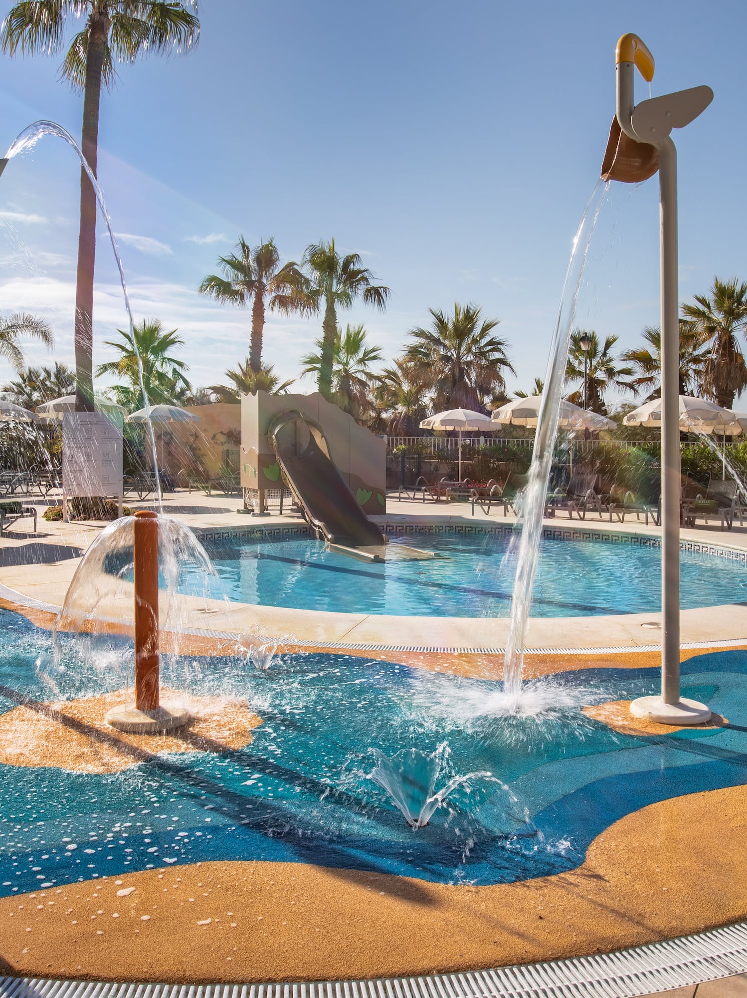 a water park with a slide and a pool