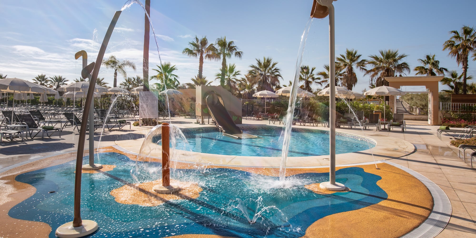 a water park with a slide and a pool