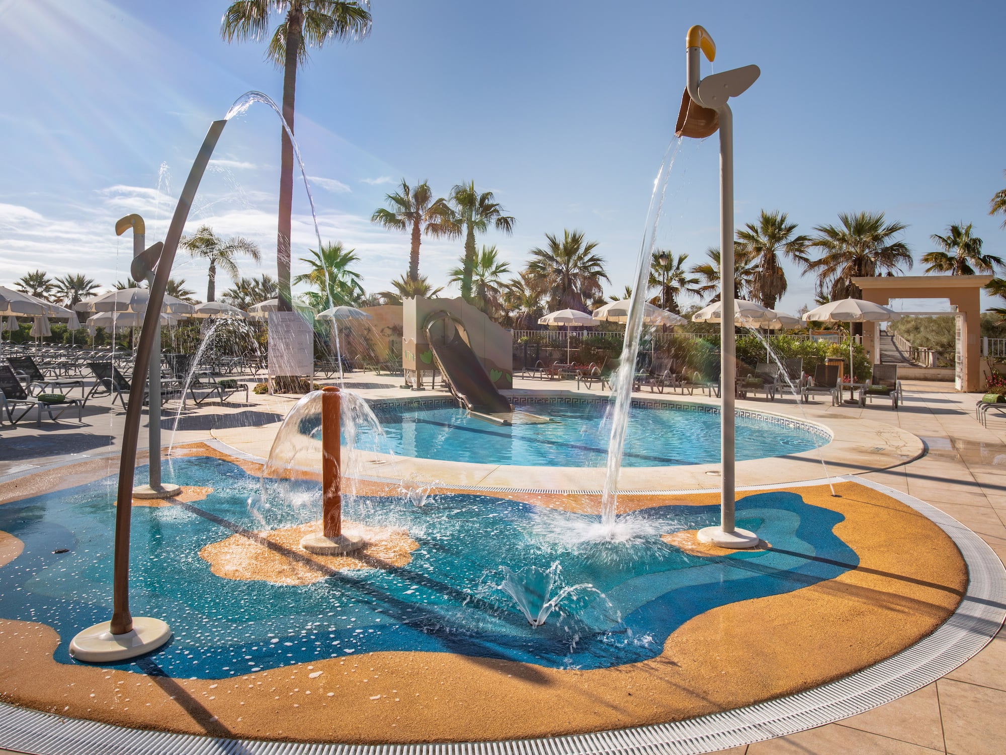 a water park with a slide and a pool