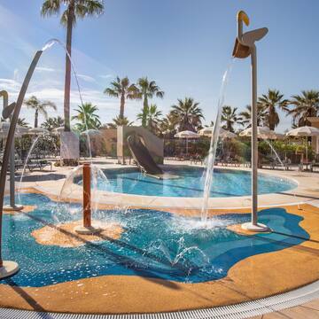 a water park with a slide and a pool