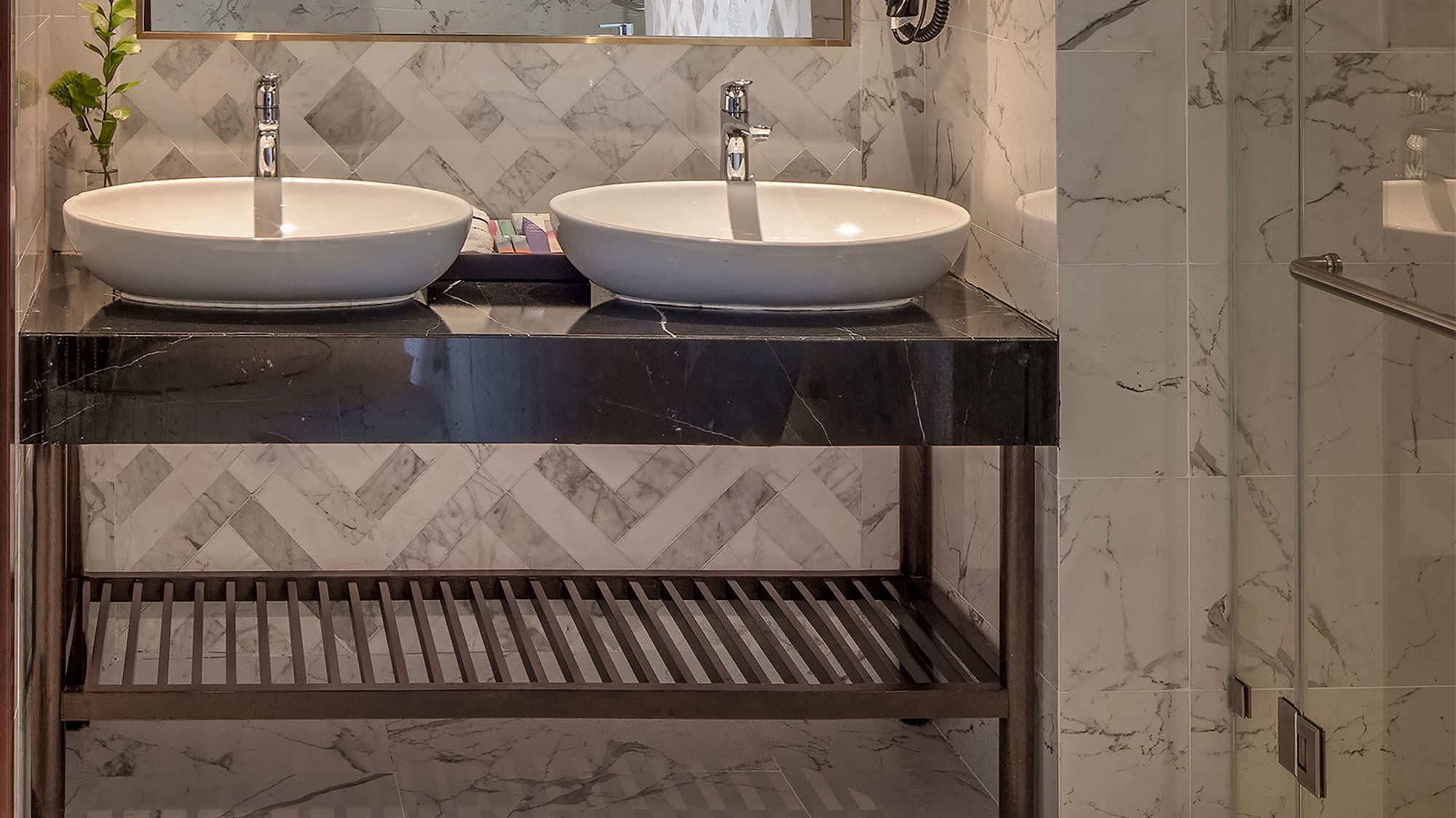 a bathroom with marble tile floor and two sinks