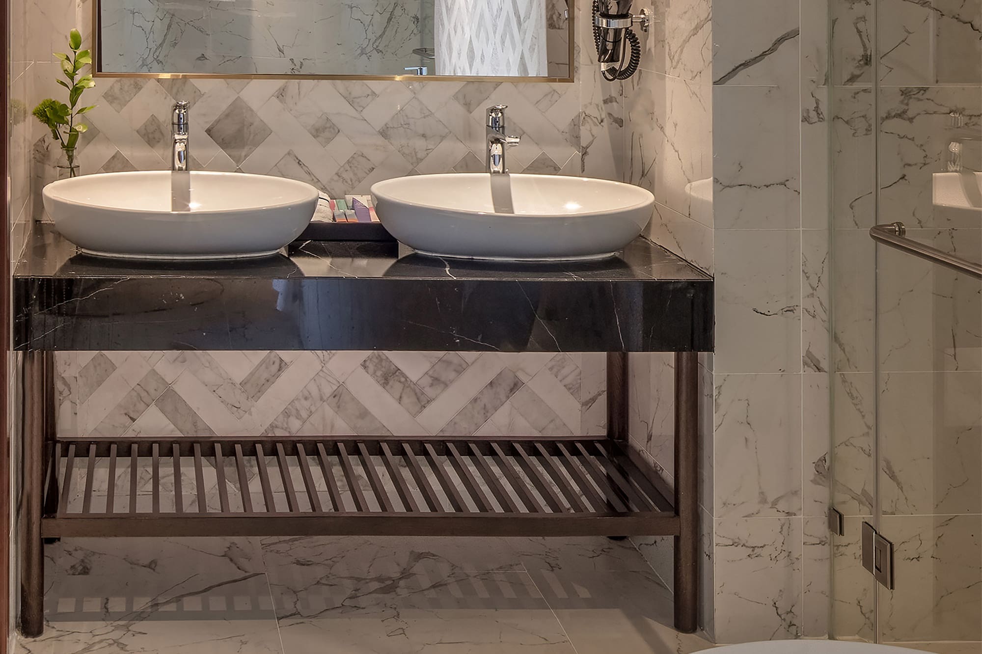 a bathroom with marble tile floor and two sinks