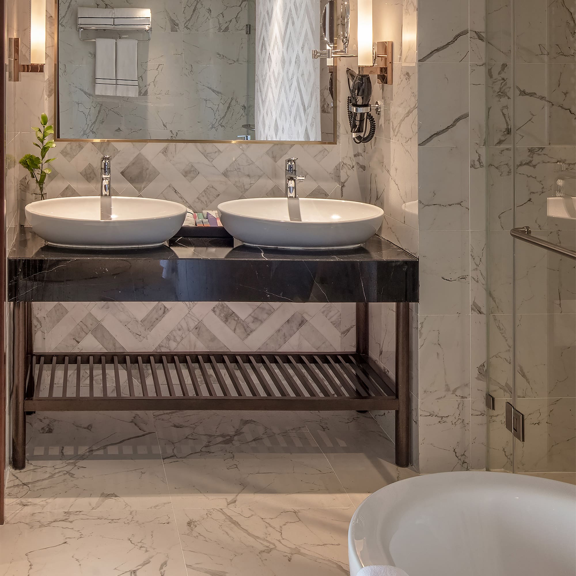a bathroom with marble tile floor and two sinks