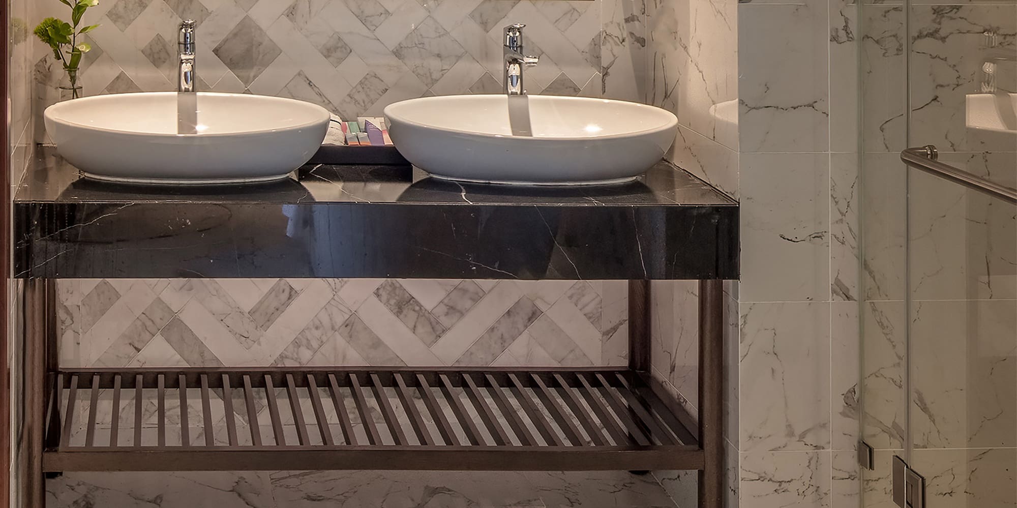a bathroom with marble tile floor and two sinks
