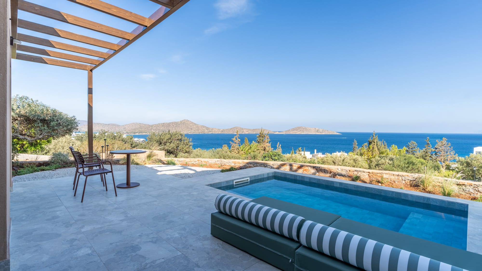 a pool with a deck and chairs