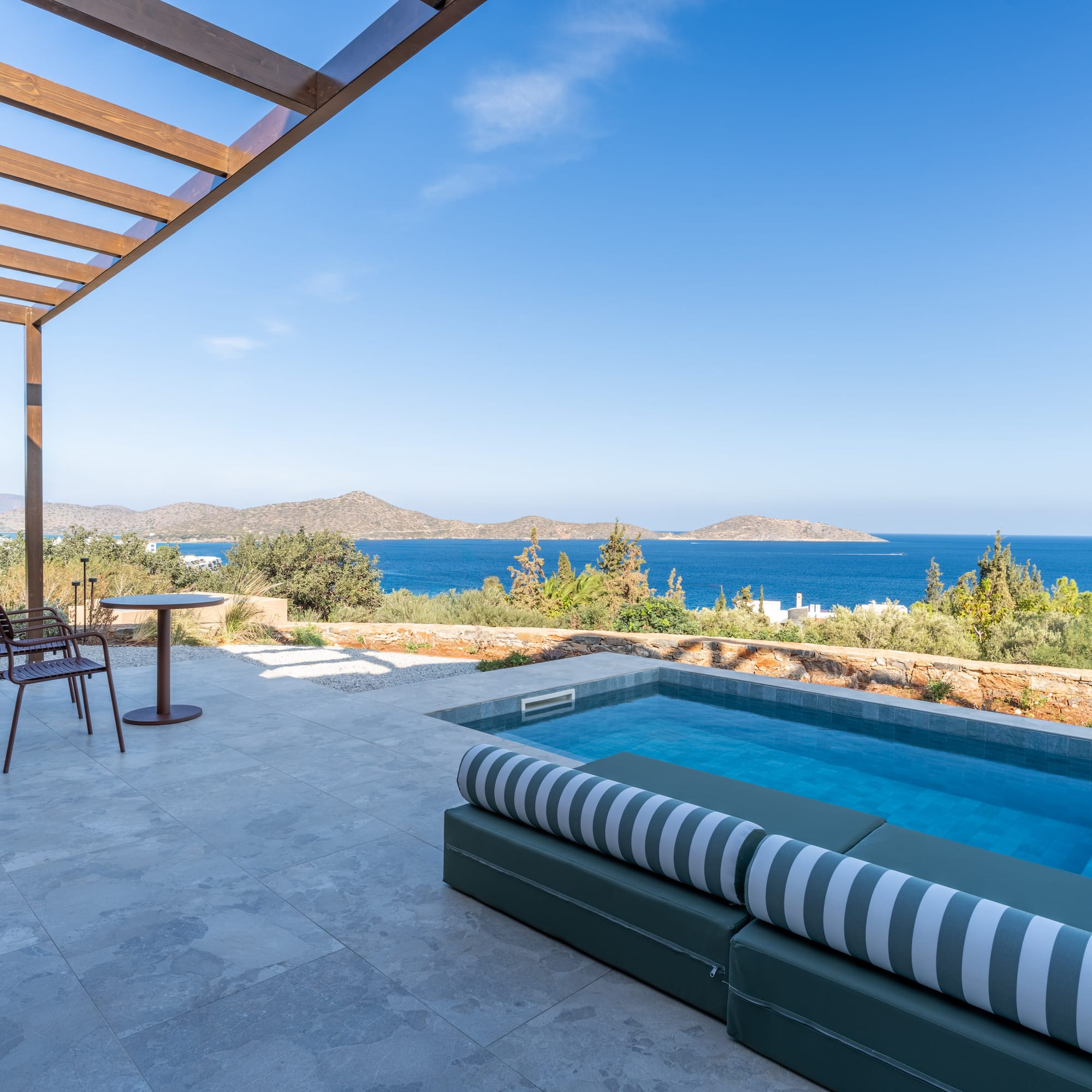 a pool with a deck and chairs