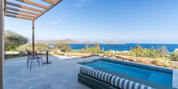 a pool with a deck and chairs