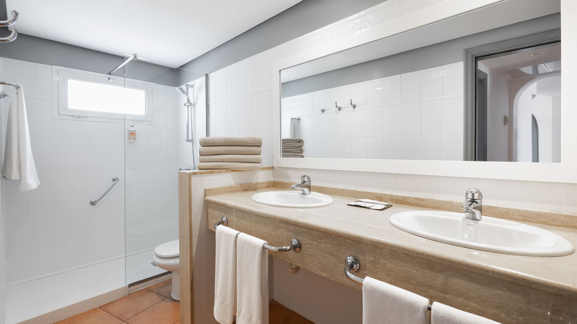 a bathroom with a shower and two sinks