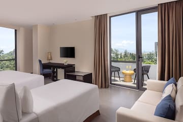 a room with two beds and a television