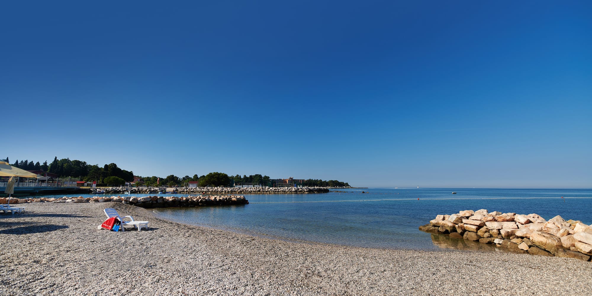 a beach with rocks and a blue sky