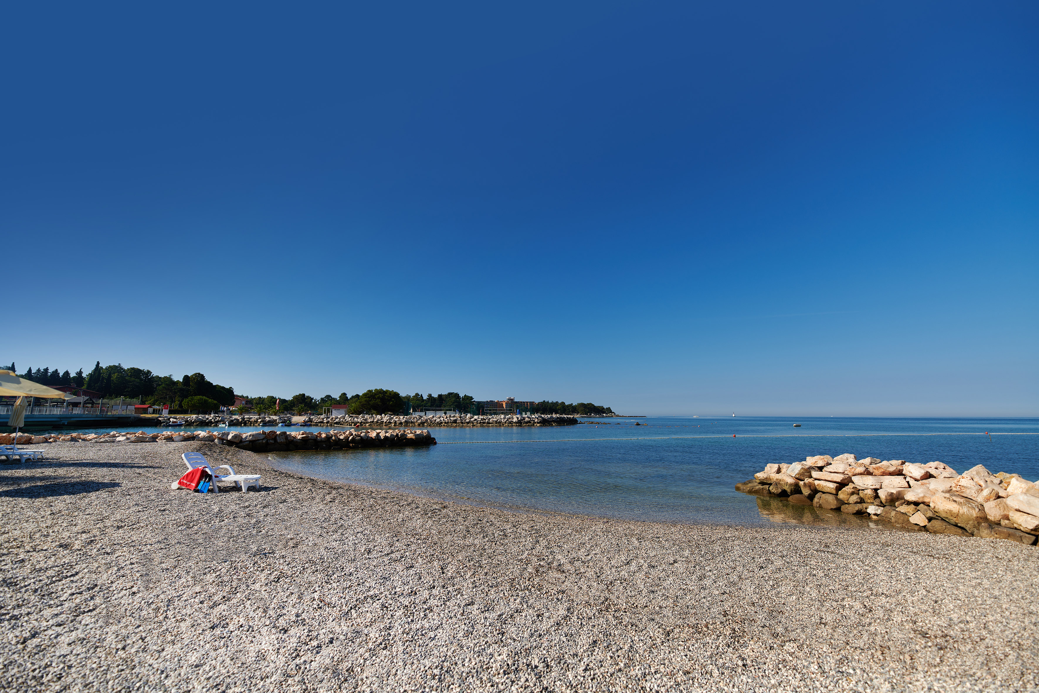 a beach with rocks and a blue sky