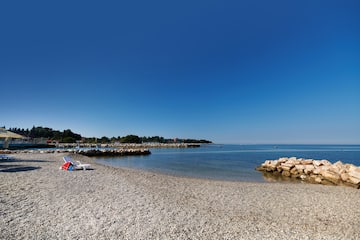 a beach with rocks and a blue sky