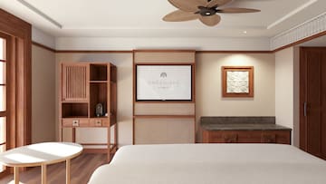 a room with a bed and a fan