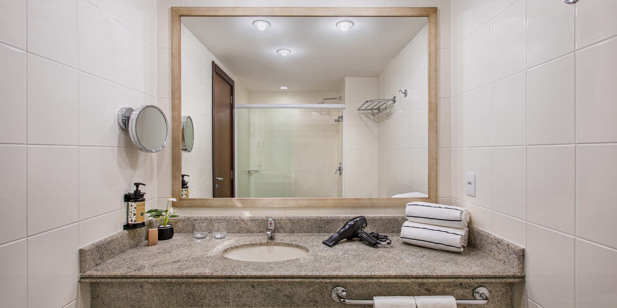 a bathroom with a mirror and a blow dryer