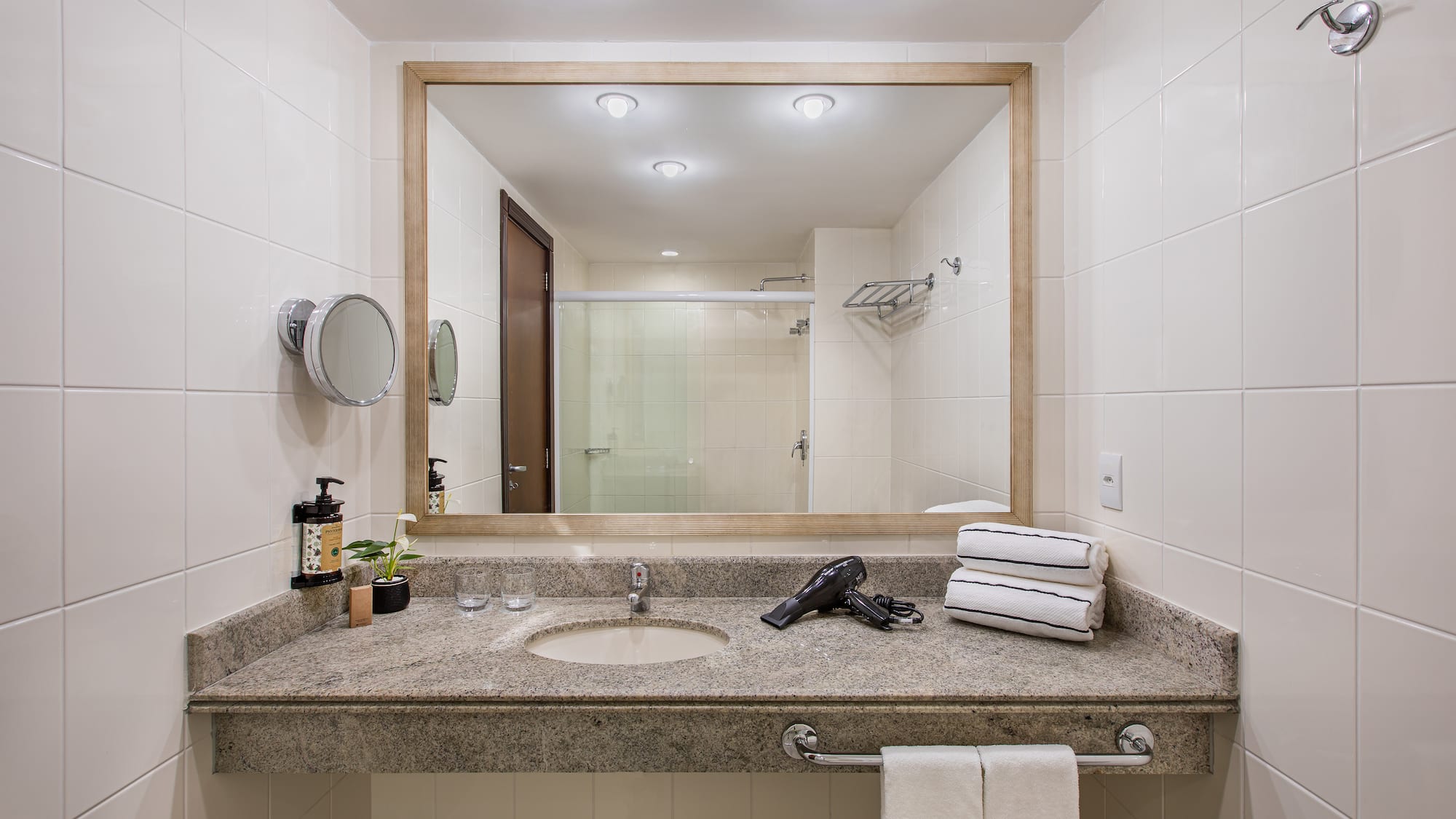 a bathroom with a mirror and a blow dryer