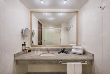 a bathroom with a mirror and a blow dryer