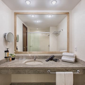 a bathroom with a mirror and a blow dryer