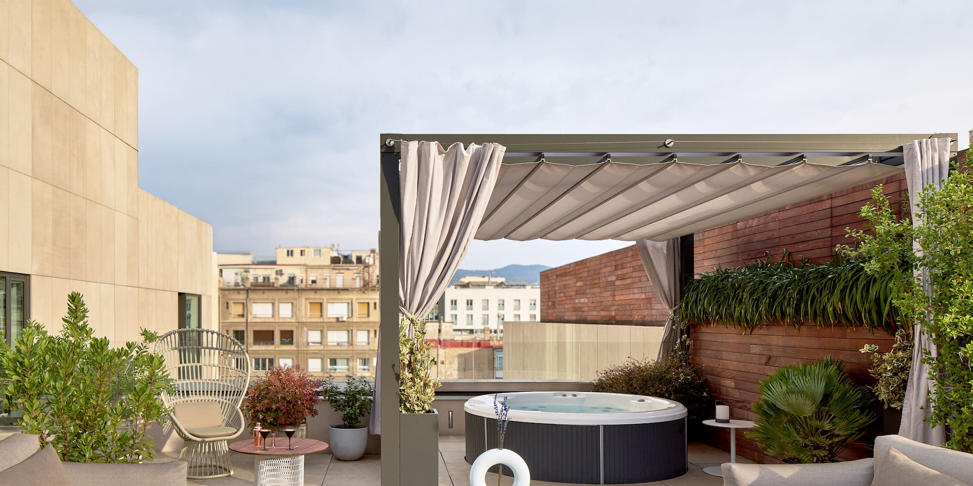 a patio with a hot tub and chairs