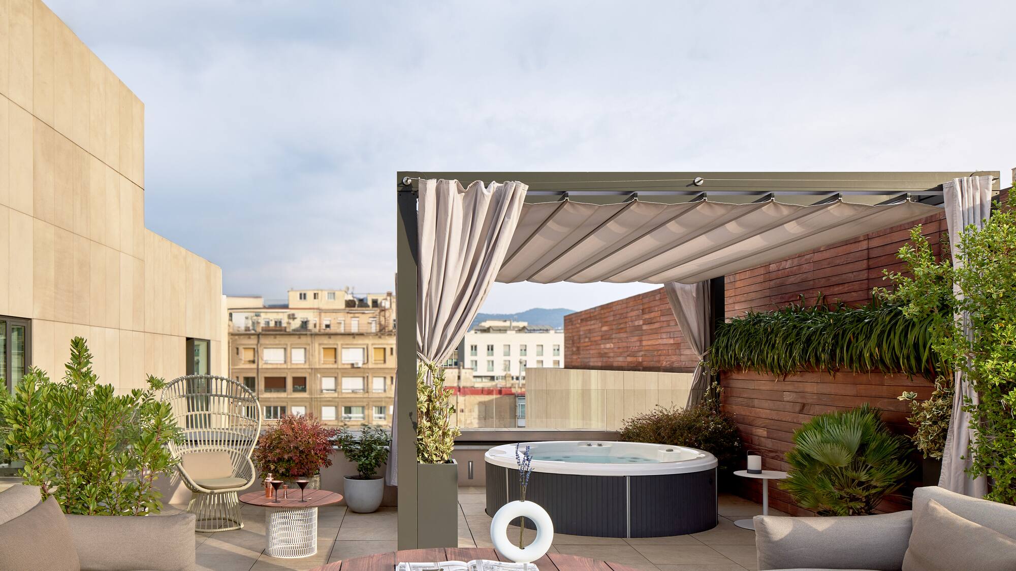 a patio with a hot tub and chairs