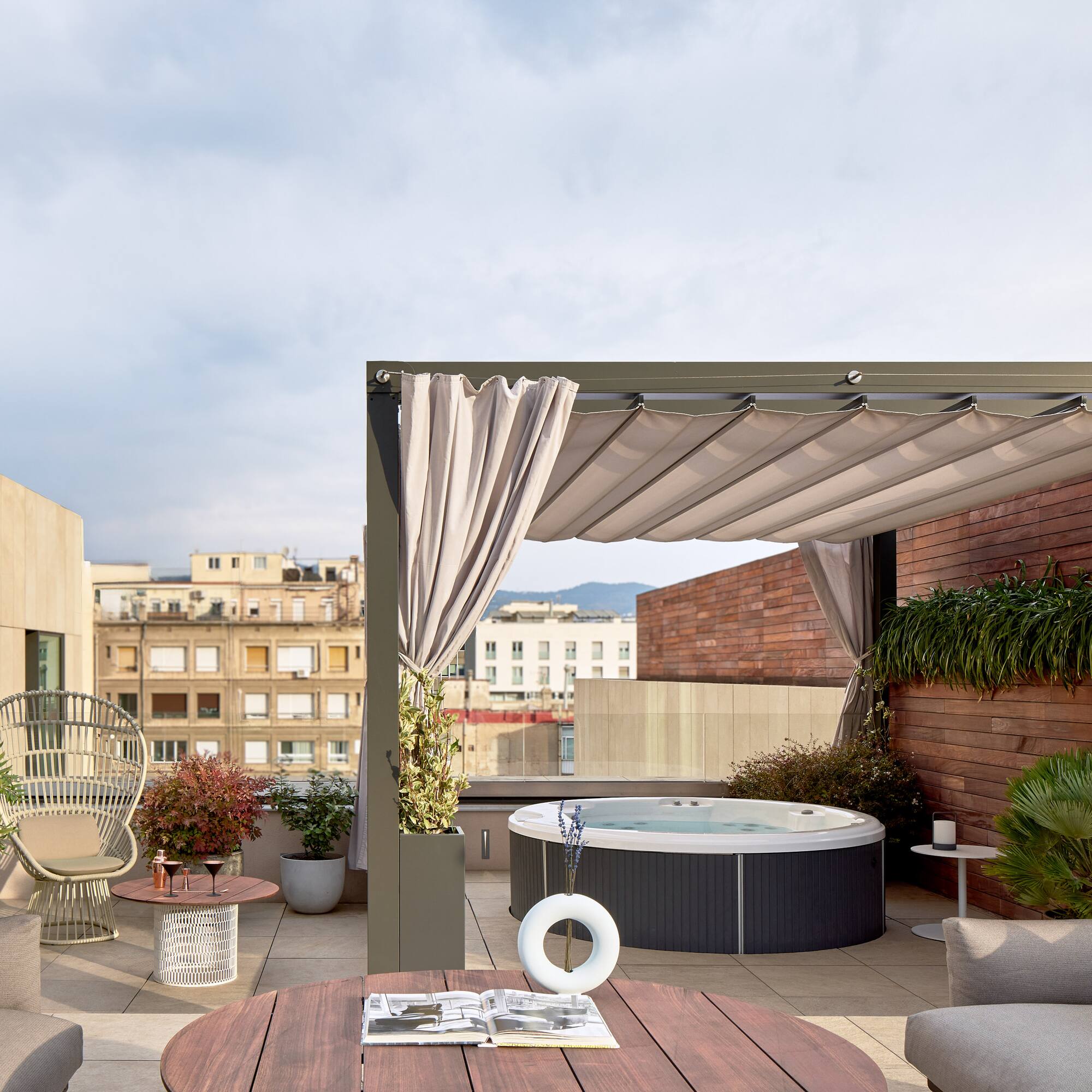 a patio with a hot tub and chairs