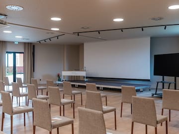 a room with chairs and a stage