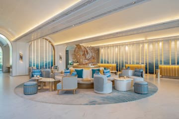 a room with a large round table and chairs