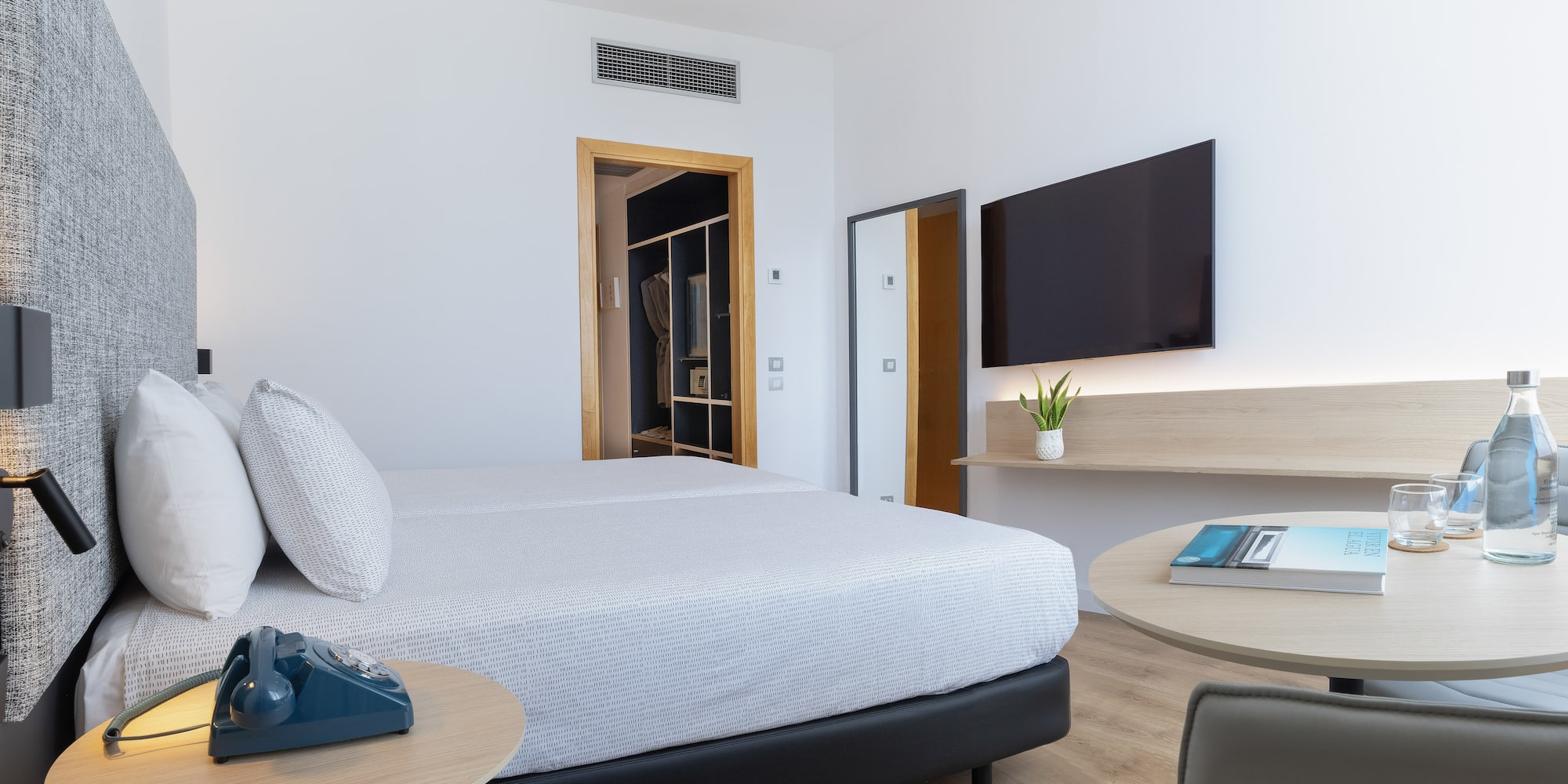 a bedroom with a bed and a television