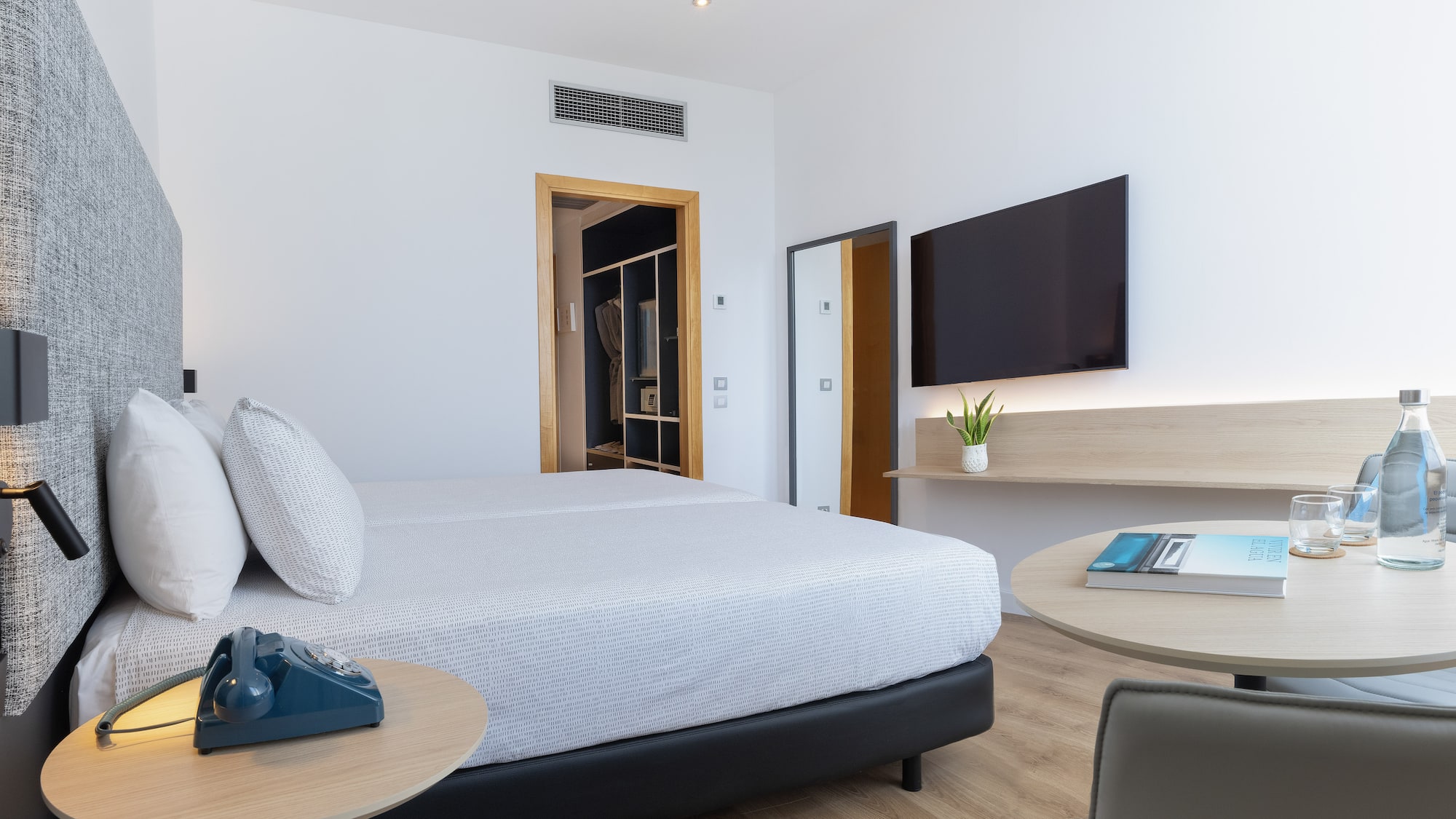 a bedroom with a bed and a television