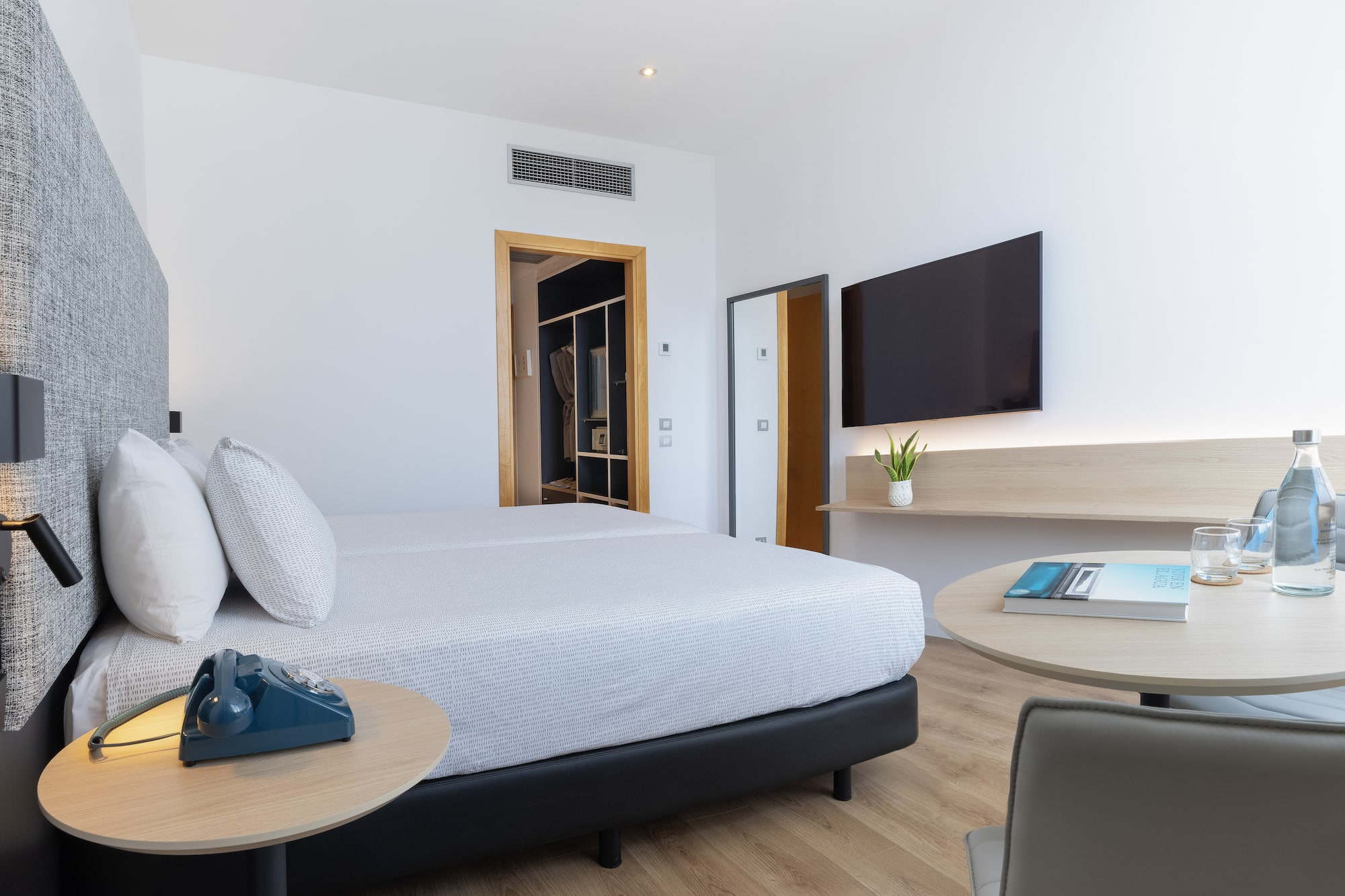 a bedroom with a bed and a television