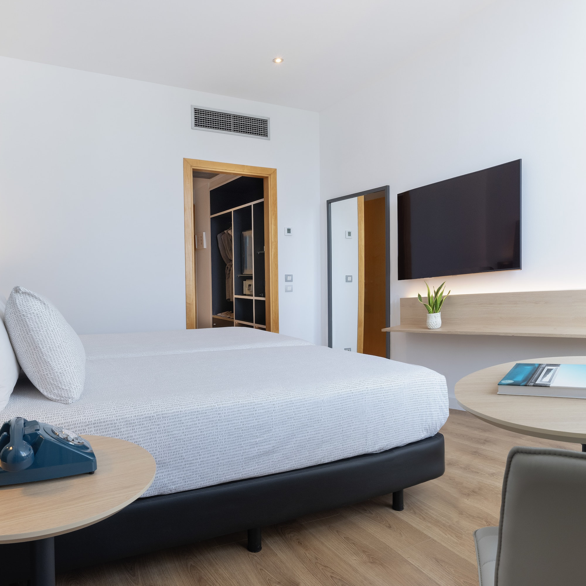 a bedroom with a bed and a television