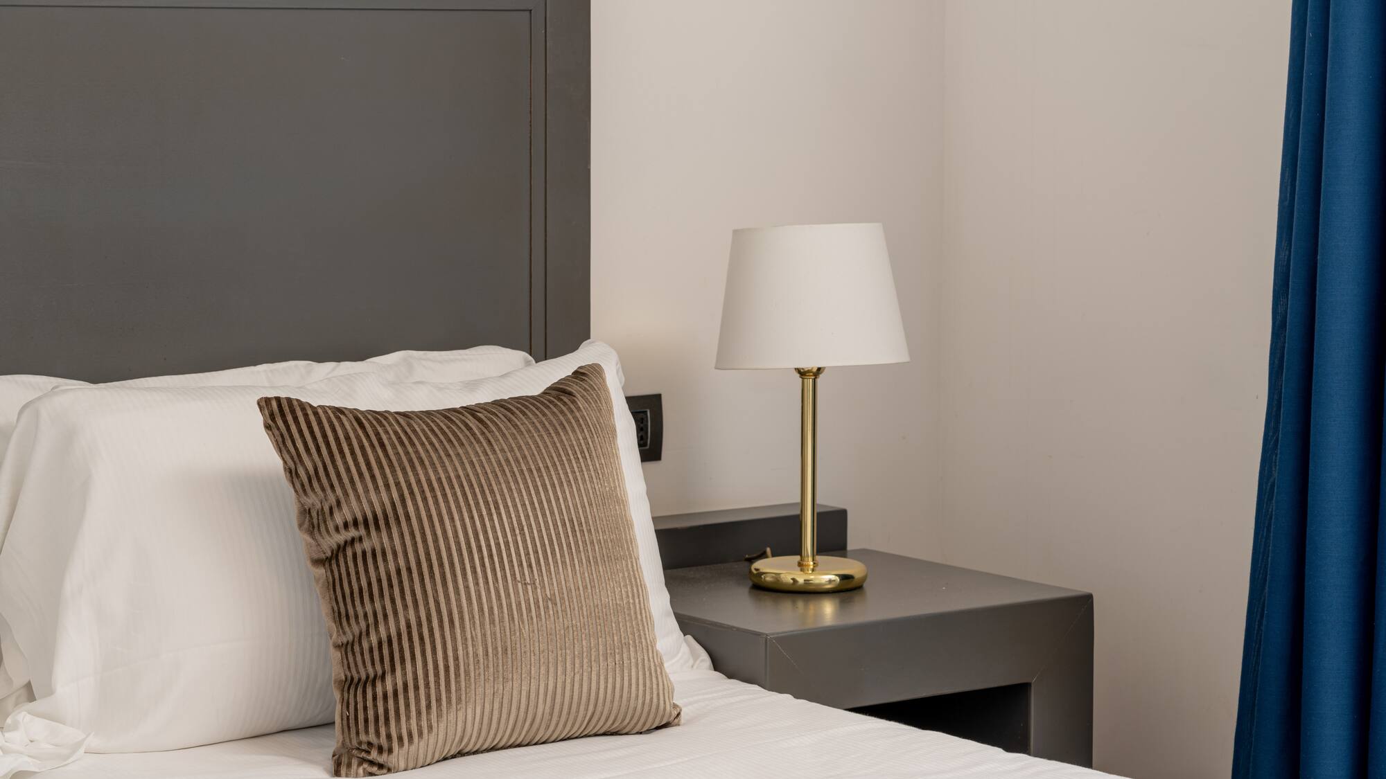 a bed with a lamp on a table