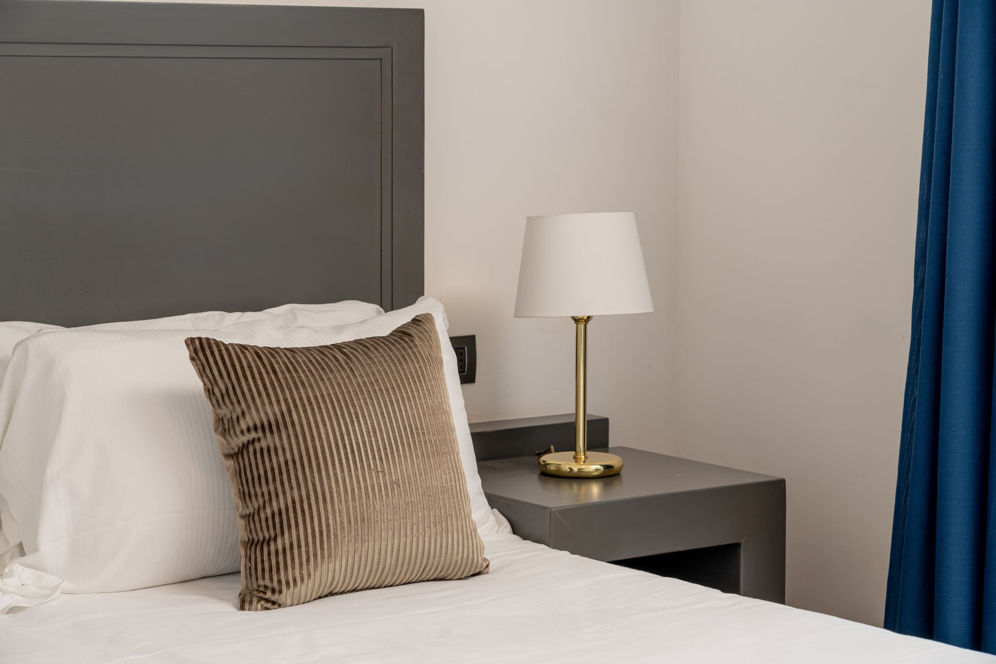 a bed with a lamp on a table