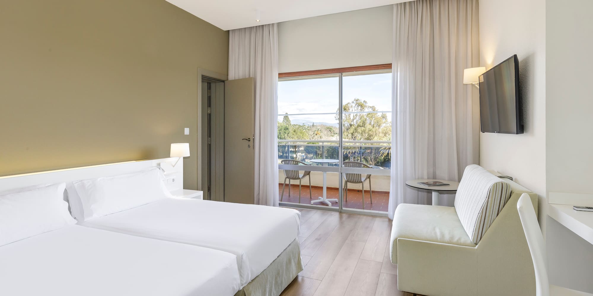 a room with two beds and a television