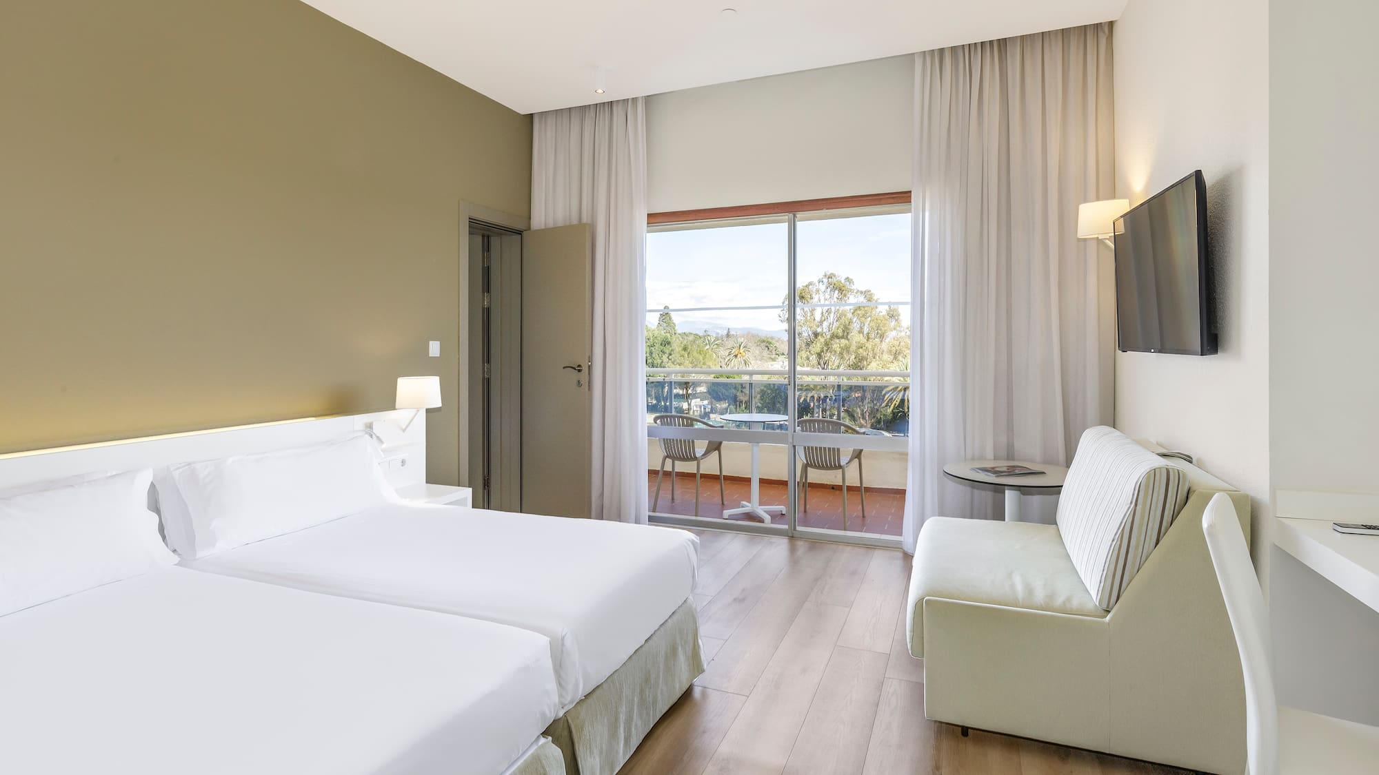 a room with two beds and a television