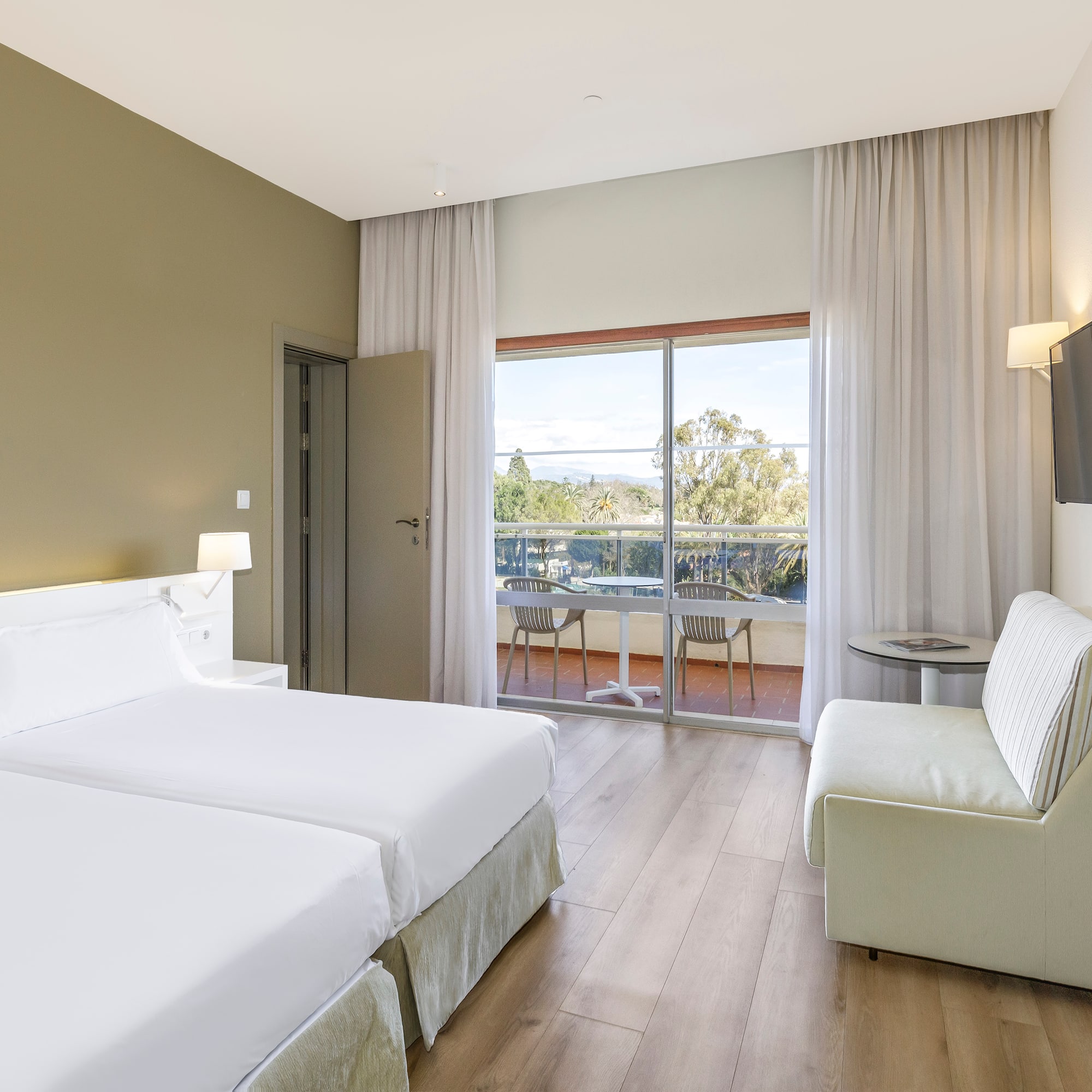 a room with two beds and a television