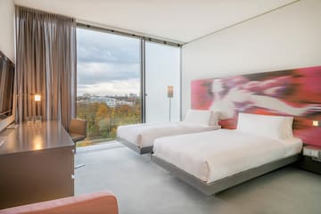 a room with two beds and a desk