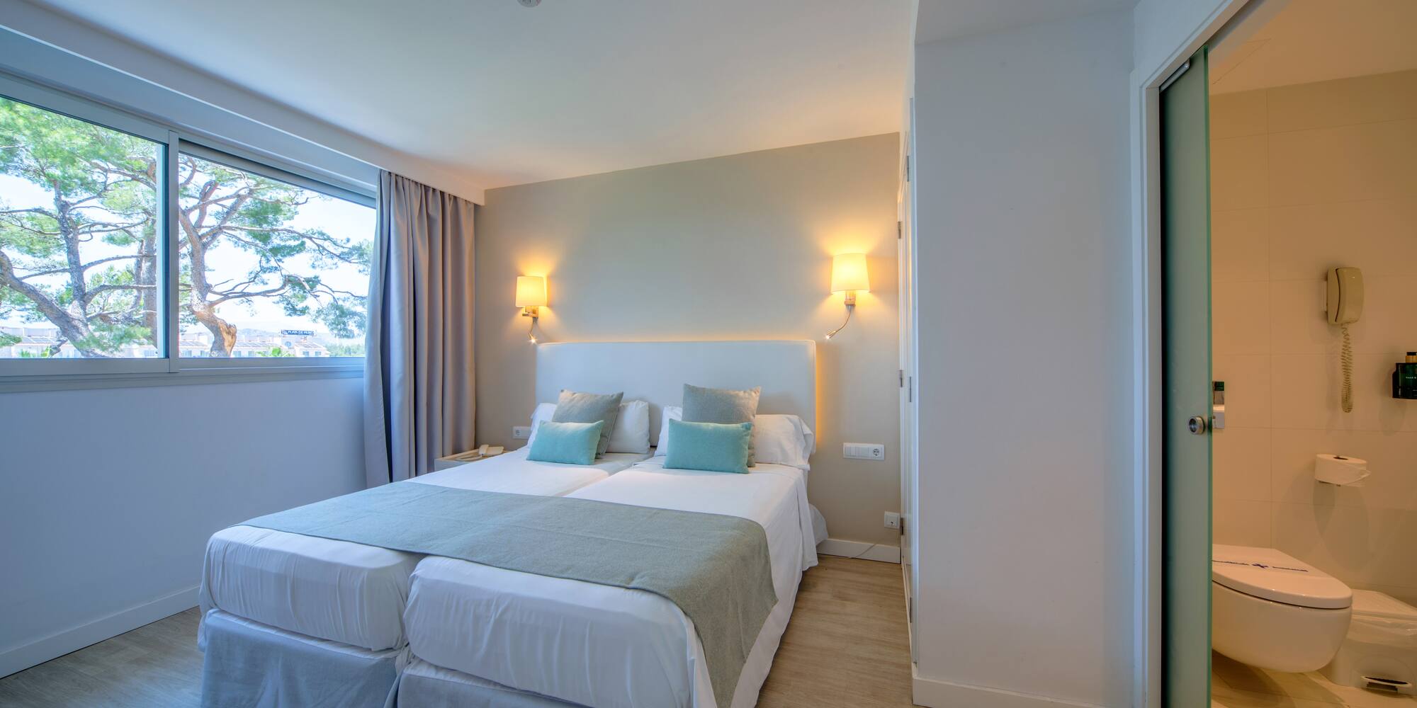 a room with two beds and a door