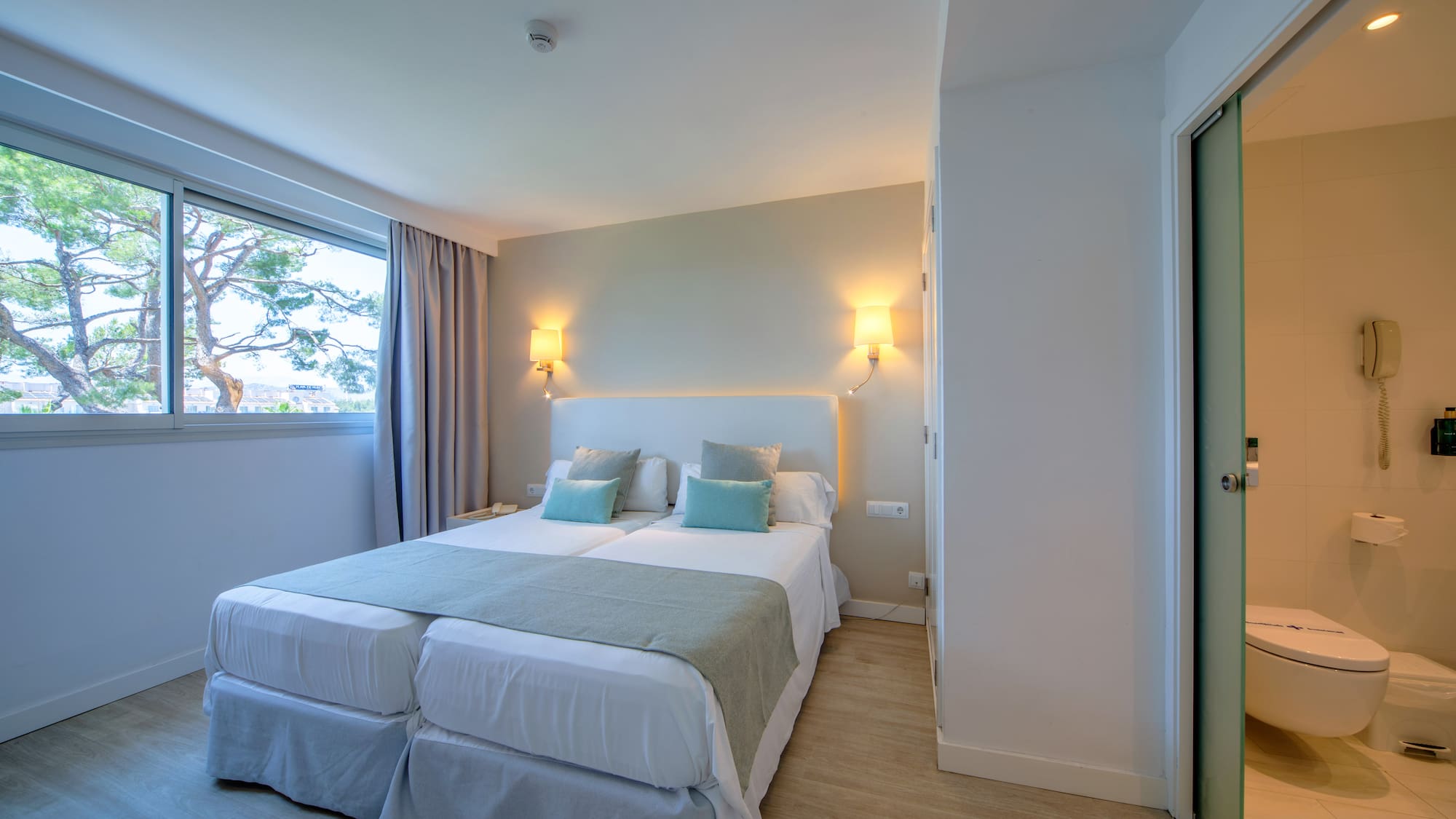 a room with two beds and a door