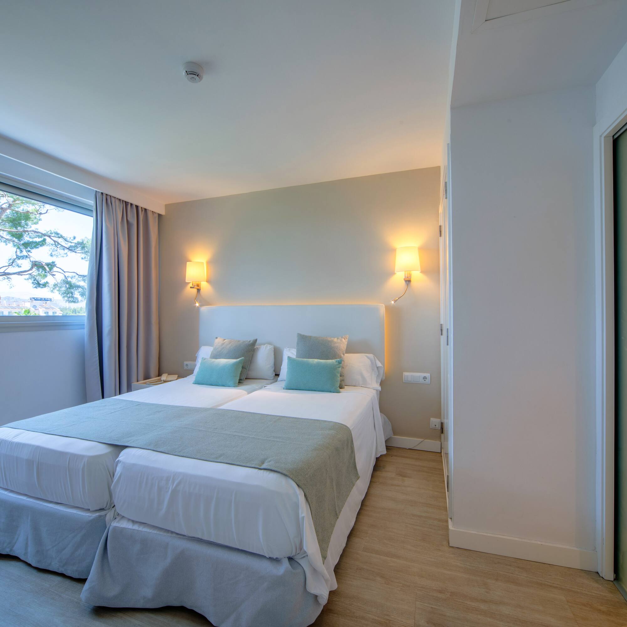 a room with two beds and a door