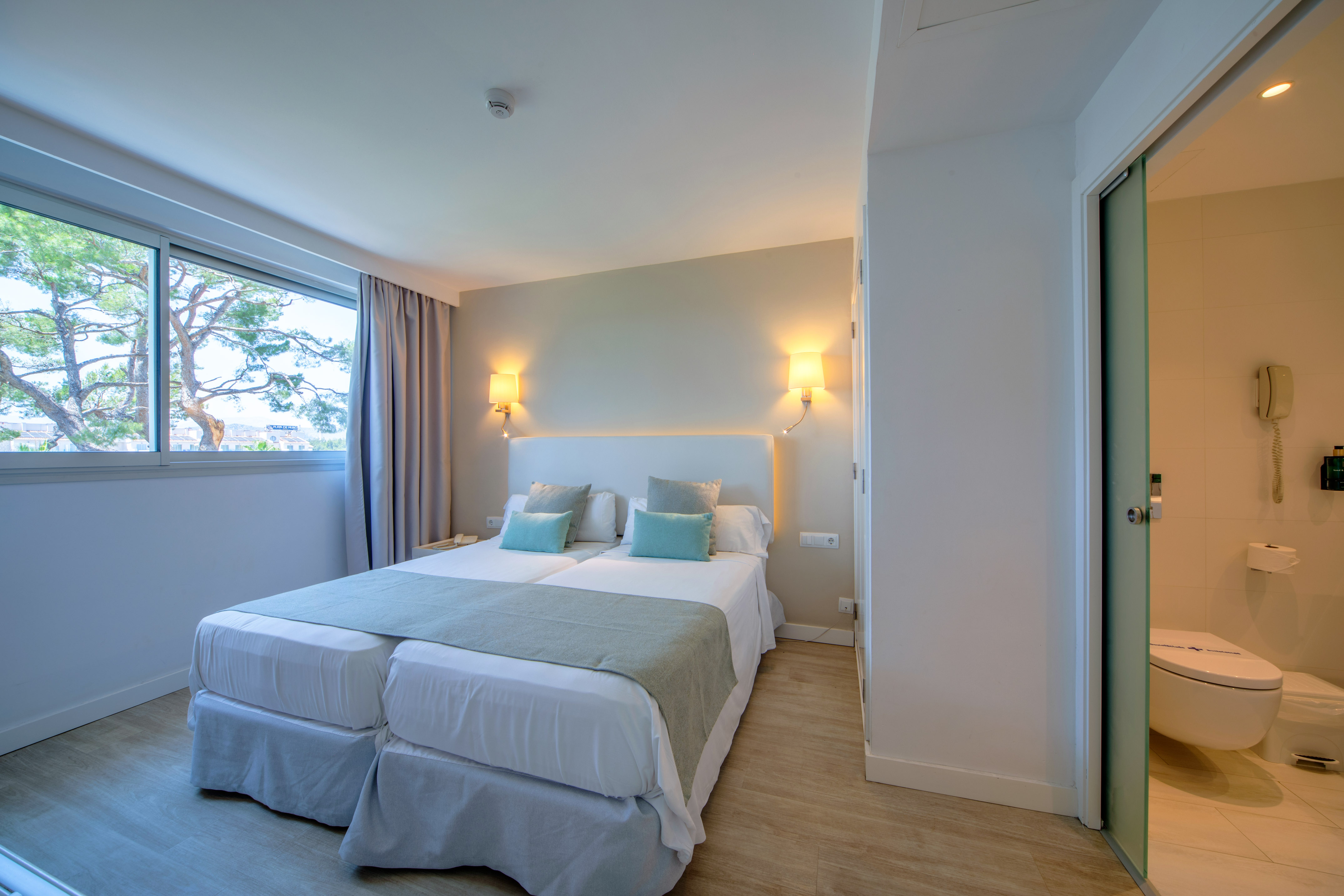 a room with two beds and a door