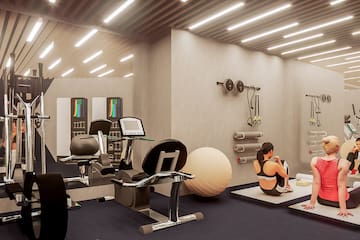 a woman sitting on the floor in a gym