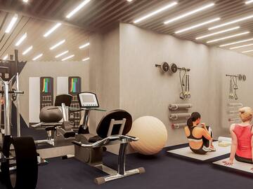 a woman sitting on the floor in a gym