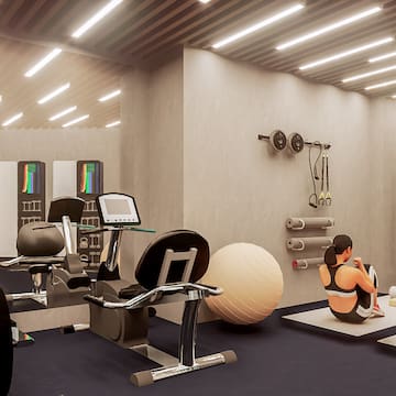 a woman sitting on the floor in a gym