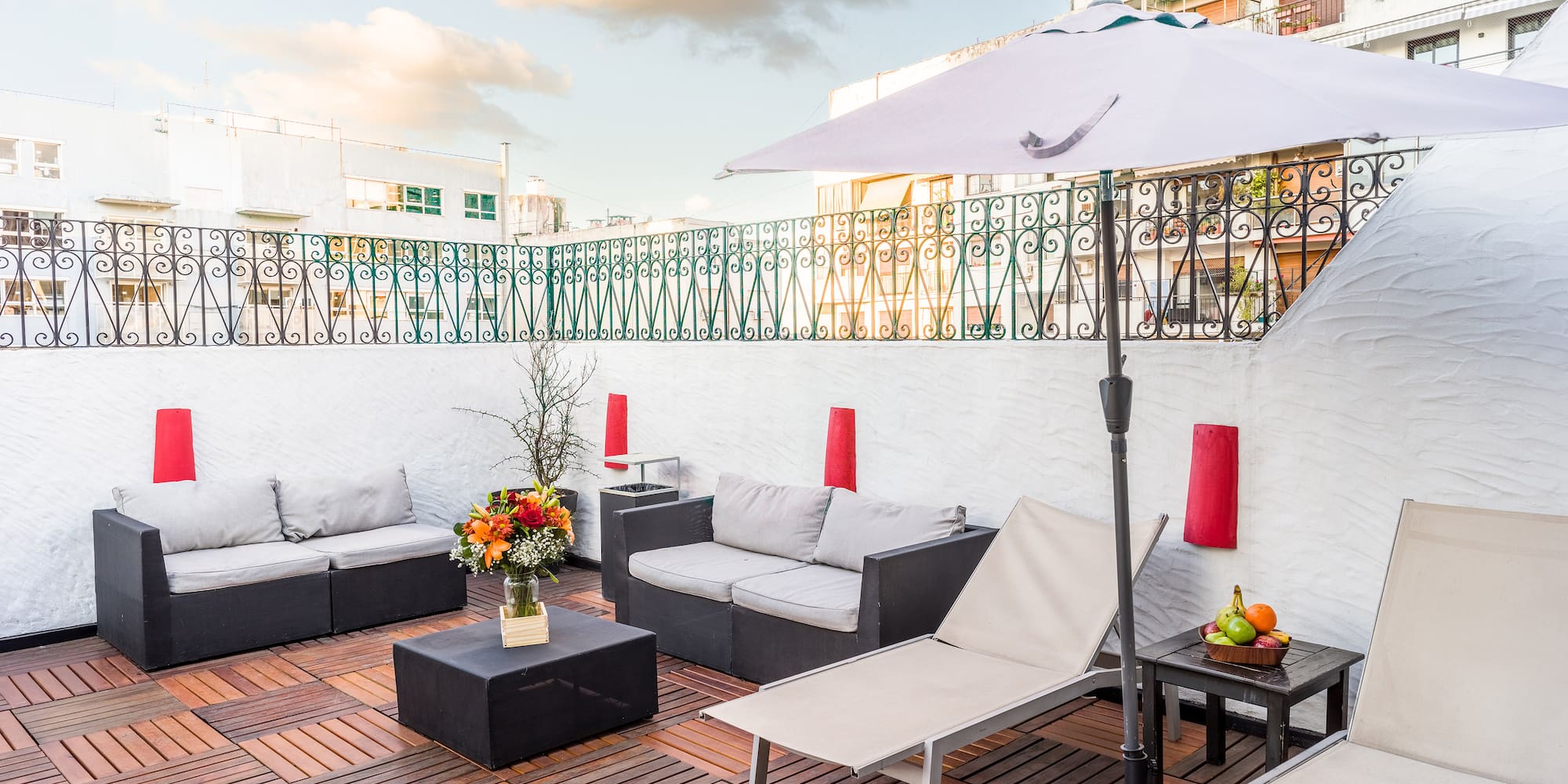 a patio with chairs and umbrella