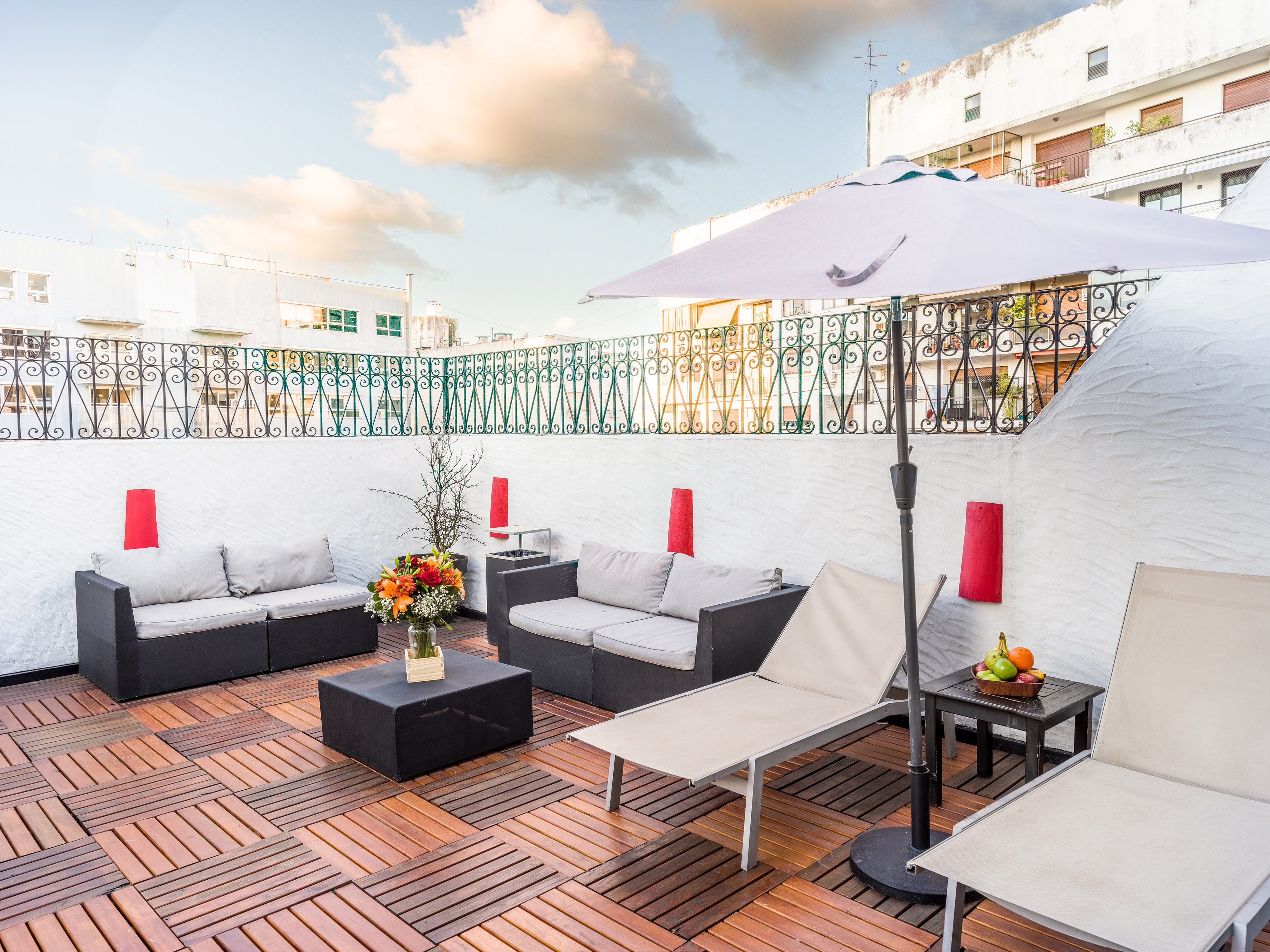 a patio with chairs and umbrella