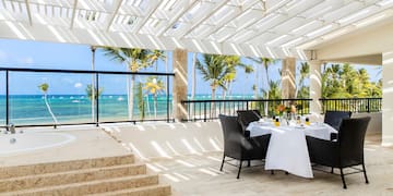 a table set up on a patio with a view of the ocean